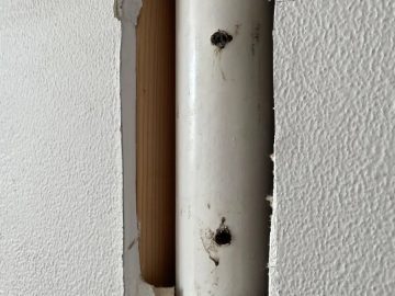 DIY drilling mistake piercing a pipe behind a wall for TV installation.
