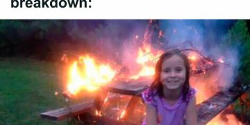 Girl smiling in front of burning table with dark humor caption
