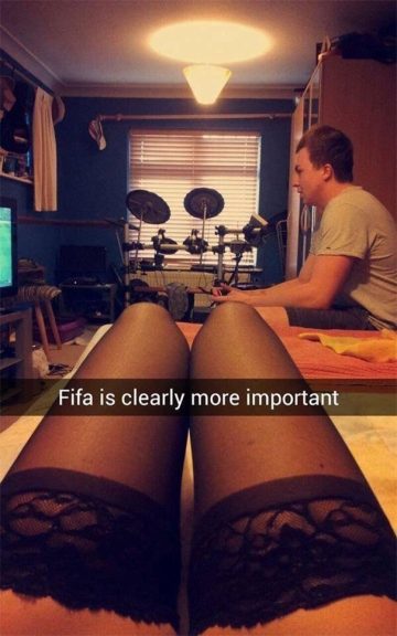 Person playing FIFA while partner looks on, captioned humor.