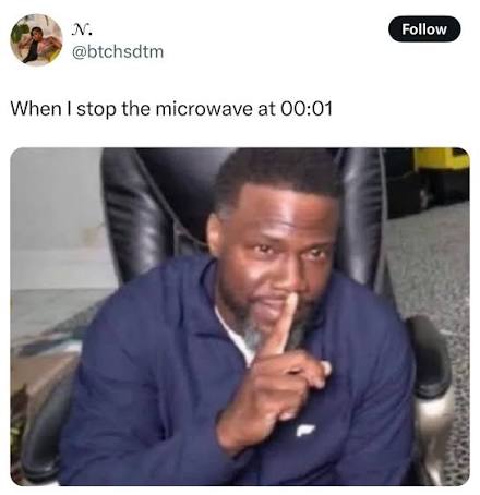 Man shushing while stopping microwave at 00:01