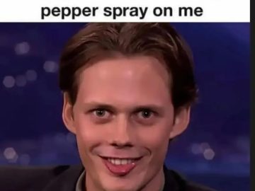 Man with funny, awkward smile after pepper spray joke.