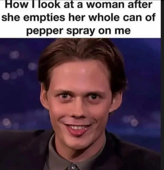 Man with funny, awkward smile after pepper spray joke.