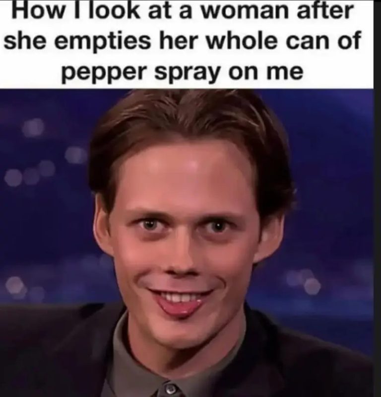 Man with funny, awkward smile after pepper spray joke.