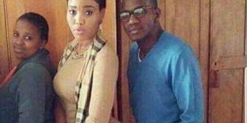 Man standing next to woman with hands in pockets, looking awkward.