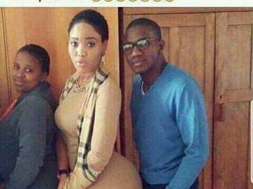 Man standing next to woman with hands in pockets, looking awkward.