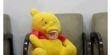 Stuffed bear on chair with shocked expression, reacting to awkward oversharing