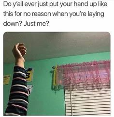 Arm raised in a bedroom, questioning its randomness.