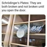 A stack of plates precariously balanced behind a glass cabinet door.