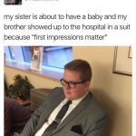 Brother in a suit at the hospital for sister's baby arrival.