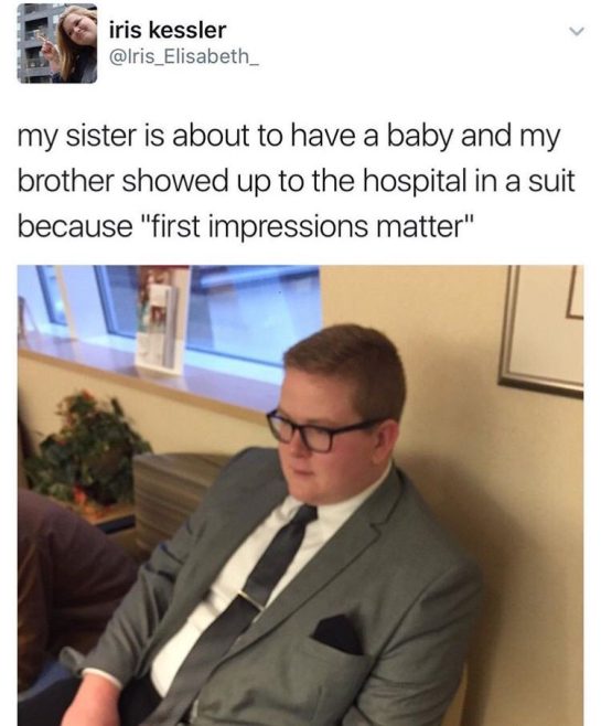 Brother in a suit at the hospital for sister's baby arrival.