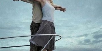 Couple on a boat deck doing Titanic pose gets interrupted by seagull.