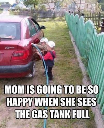 Child attempting to fill car gas tank with water hose.