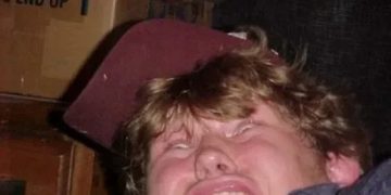 Man making a funny face reacting to toilet water splash.