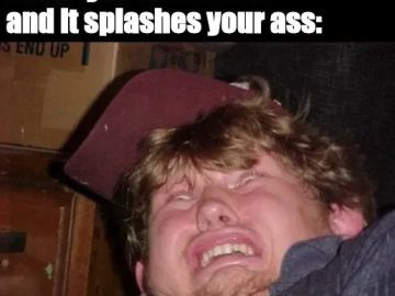 Man making a funny face reacting to toilet water splash.