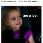 Little girl giving side-eye to someone sitting next to her.