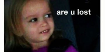 Little girl giving side-eye to someone sitting next to her.