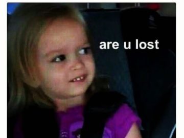 Little girl giving side-eye to someone sitting next to her.