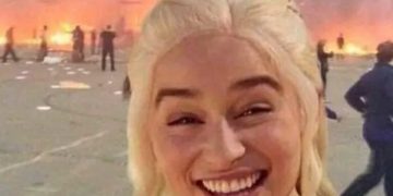 Meme of smiling person leaving work with chaos in the background