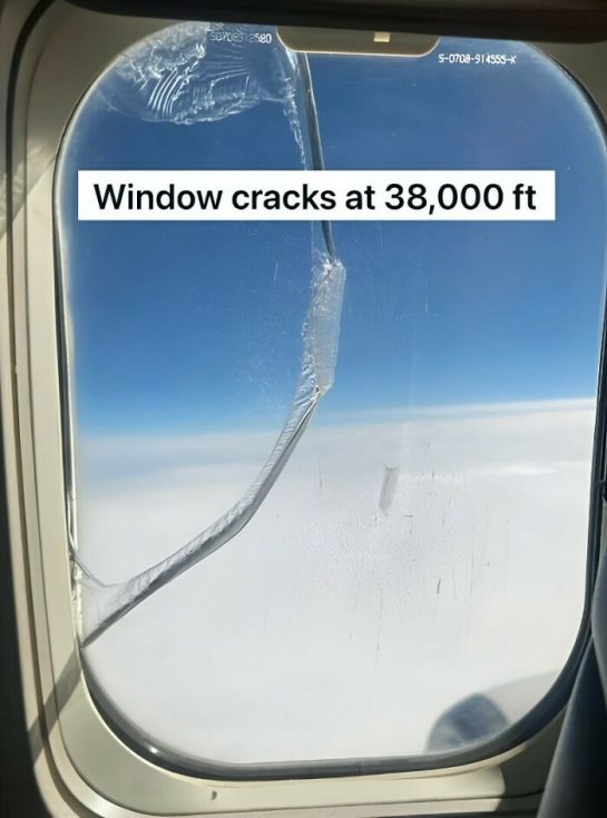 Cracked airplane window at high altitude, 38,000 feet.