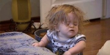 Sleepy child taking a nap, captioned "When life is just too much."