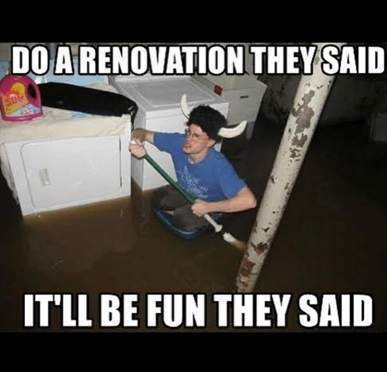 Person in flooded basement during renovation fail, paddling with a broom.