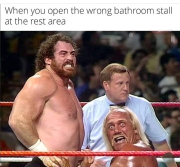 Wrestlers looking shocked after opening wrong bathroom stall