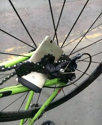 Phone stuck in bike wheel spokes in an epic fail moment.