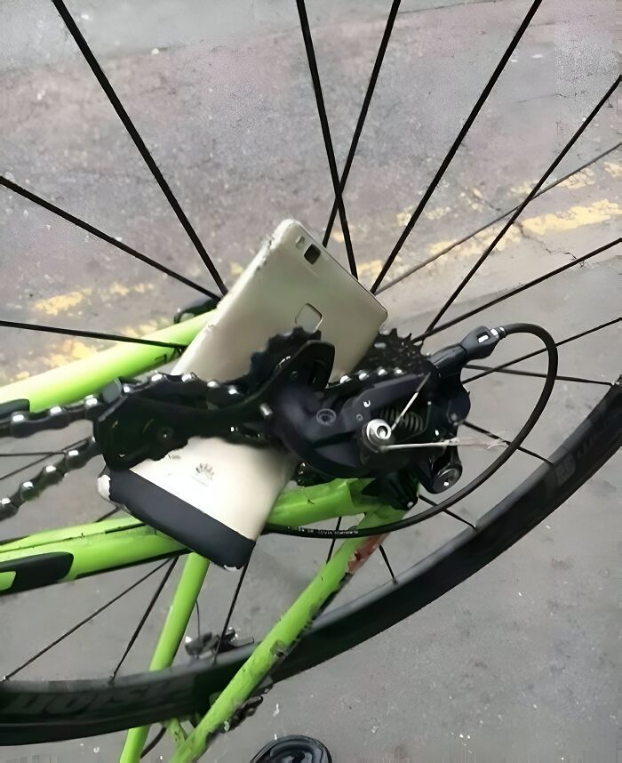 Phone stuck in bike wheel spokes in an epic fail moment.