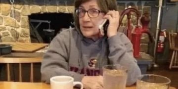 Woman humorously calling in sick to a place she doesn't work at.