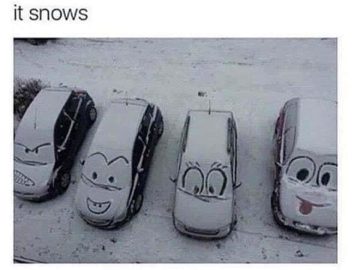 Cars with cartoon faces drawn in snow on their windshields.