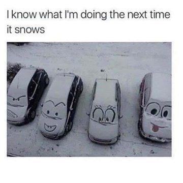 Cars with cartoon faces drawn in snow on their windshields.