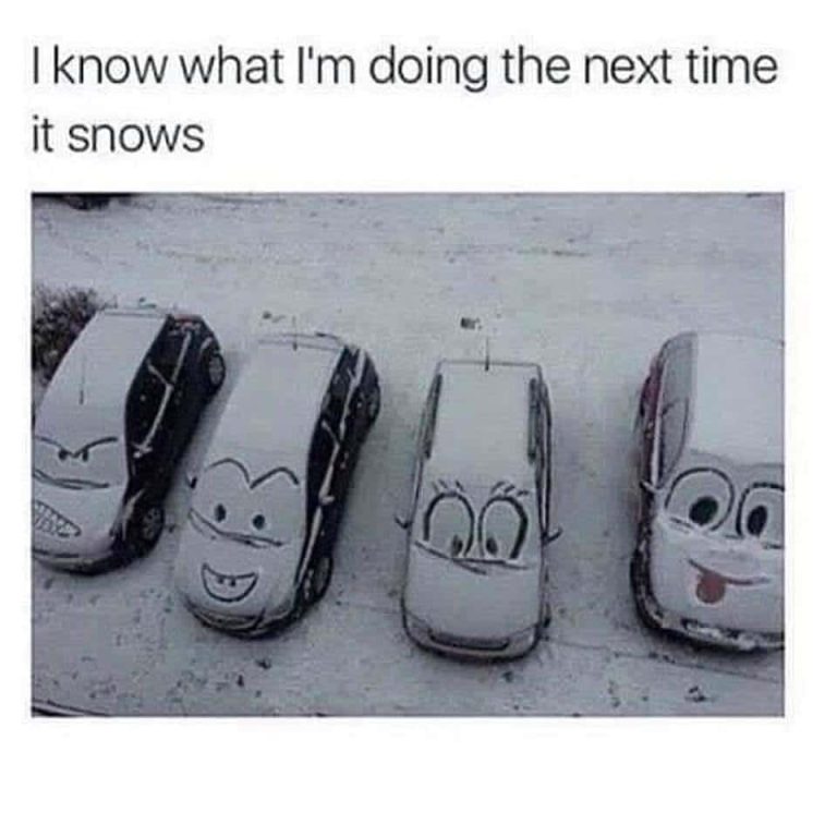 Cars with cartoon faces drawn in snow on their windshields.