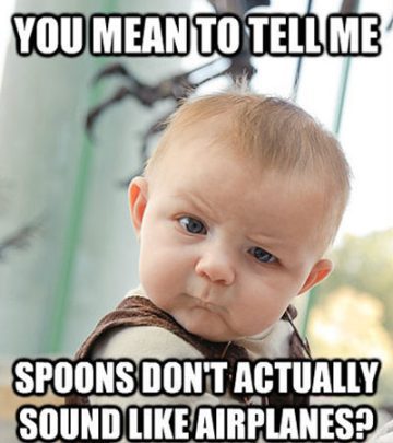 Baby looking confused, questioning why spoons don't sound like airplanes.
