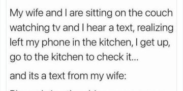 Husband checks phone in kitchen for wife's text asking for chips.