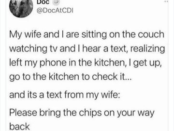 Husband checks phone in kitchen for wife's text asking for chips.
