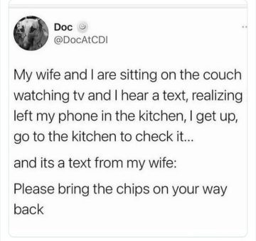 Husband checks phone in kitchen for wife's text asking for chips.