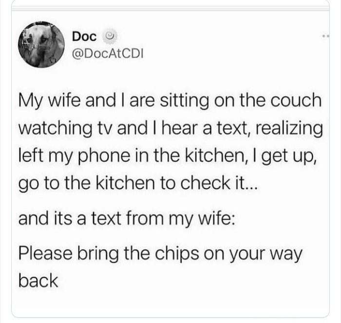 Husband checks phone in kitchen for wife's text asking for chips.