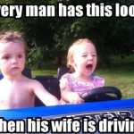 Toddler driving toy car with serious passenger expression