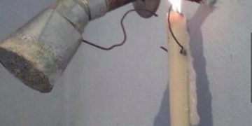 Creative DIY engineering fail using candle to fix faucet leak.