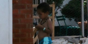 Child looking at phone for music to match chore energy