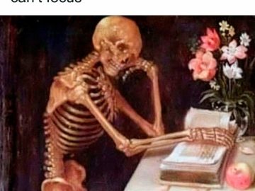 Skeleton struggling to focus on reading a book with flowers nearby.