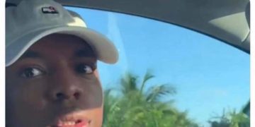 Student looking surprised during exam after teacher comment.