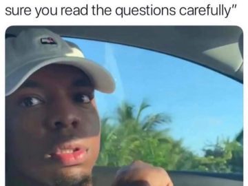 Student looking surprised during exam after teacher comment.