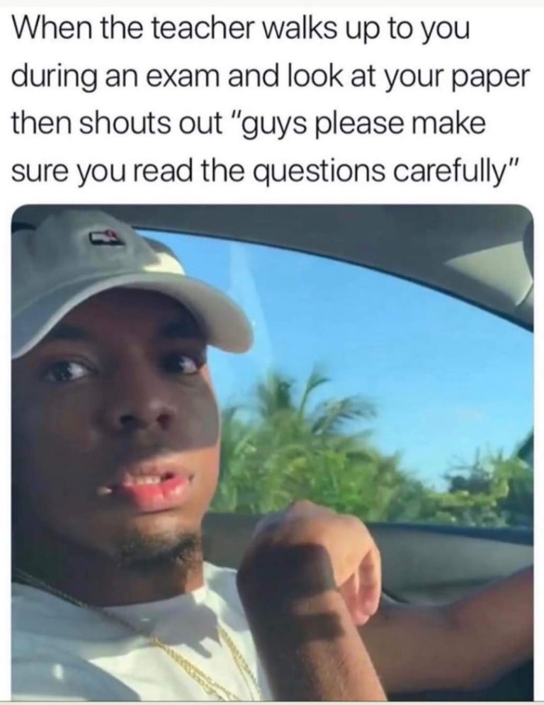 Student looking surprised during exam after teacher comment.