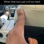 Hand gripping car seat tightly during sharp turn.