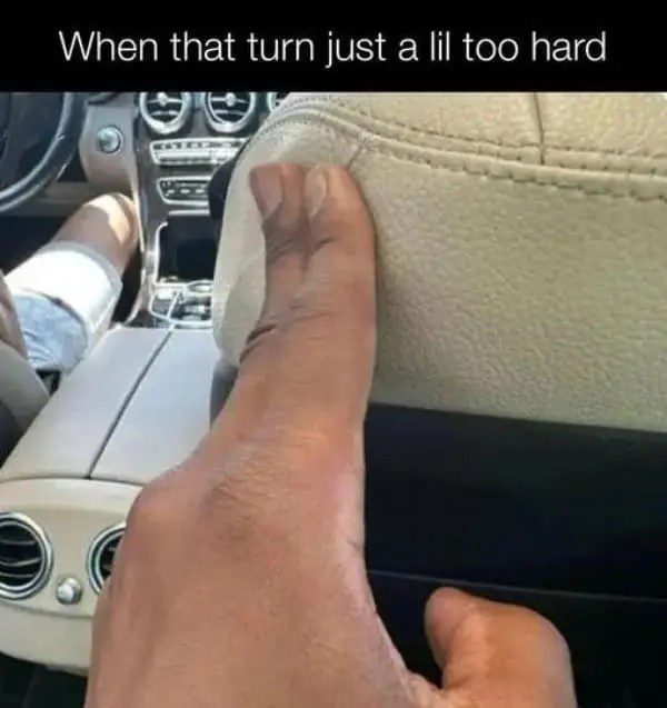 Hand gripping car seat tightly during sharp turn.