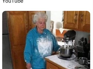 Elderly woman covered in flour after a baking fail in the kitchen.