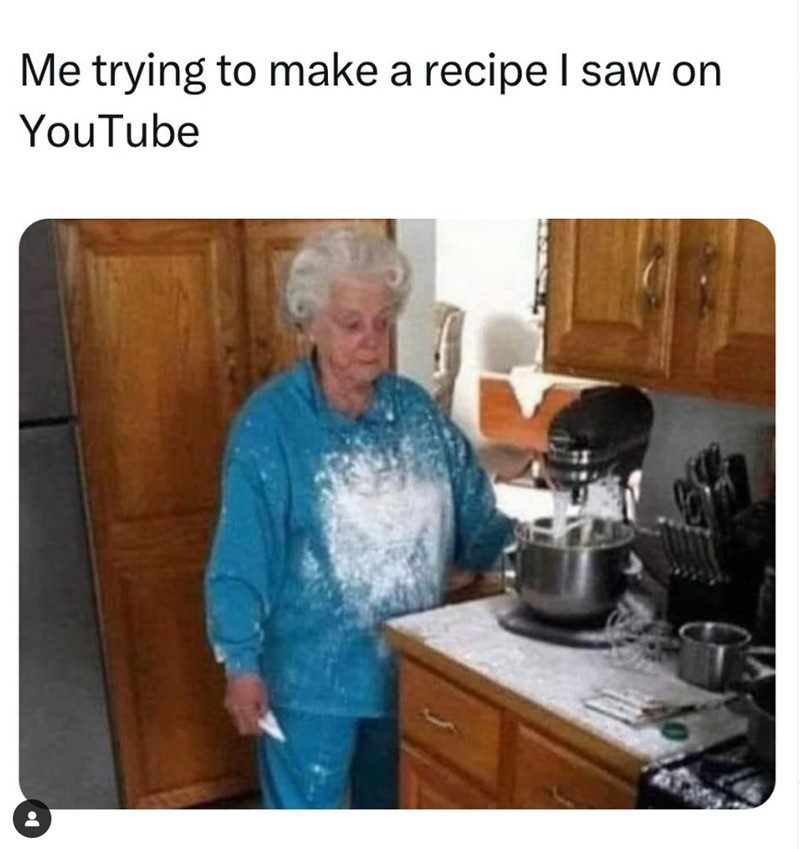 Elderly woman covered in flour after a baking fail in the kitchen.