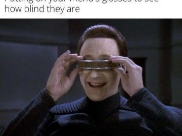 Person tries friend's glasses; humorous vision test moment.