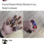 Hand holding toy rings, jokingly called Infinity Stones.